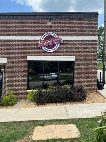 a view of a wooden house with a large tree