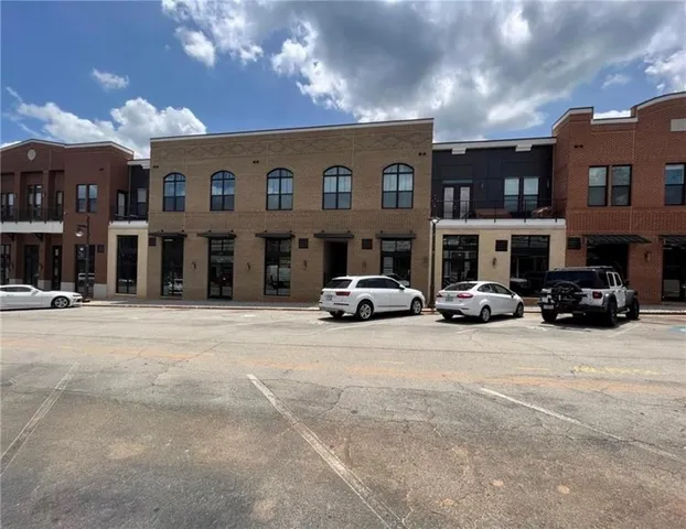 a view of swimming pool with seating area and trees in the background