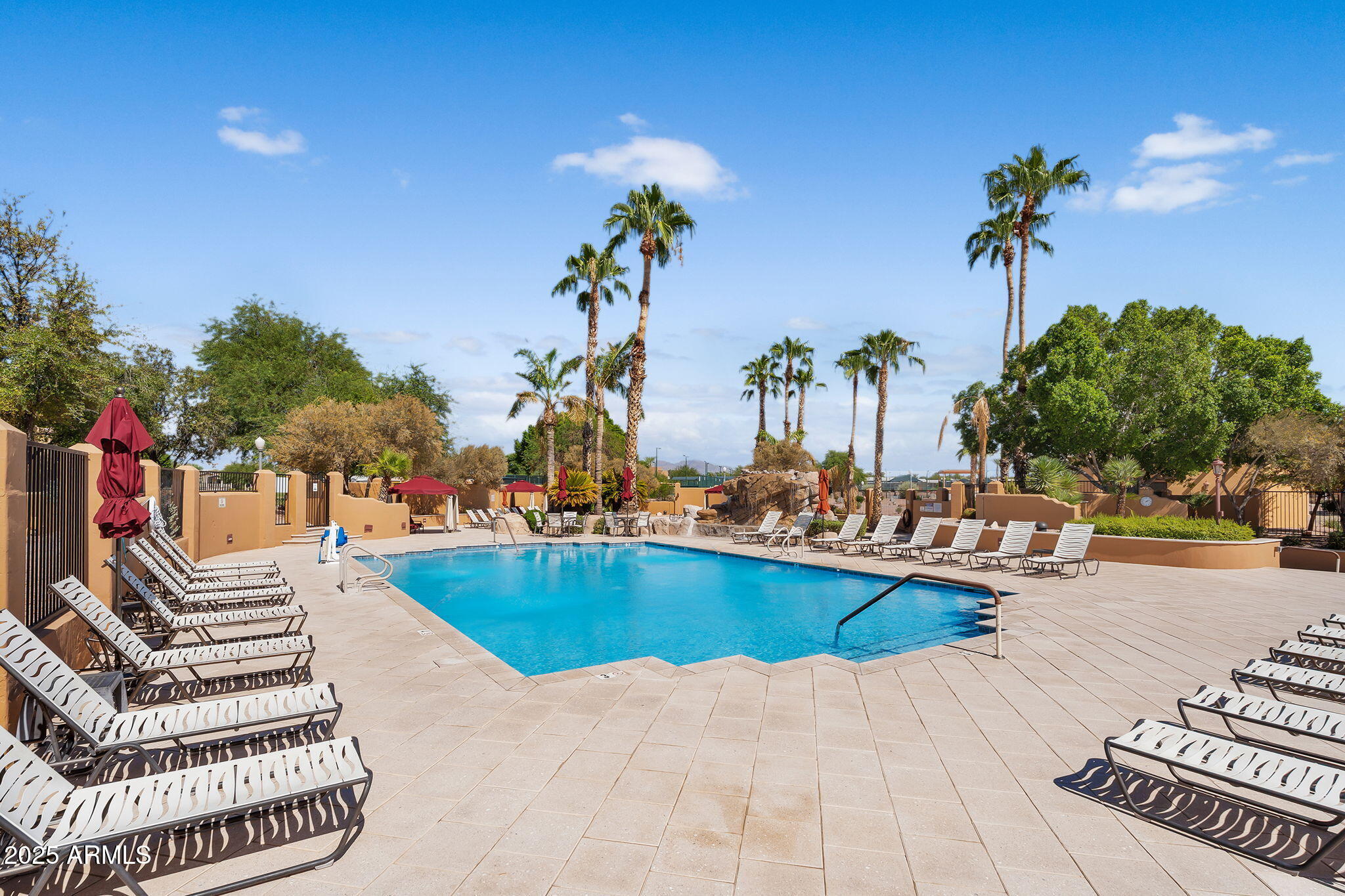8865 East Baseline Road, Unit 802 Mesa, AZ 85209 - Photo 35 of 44 a view of a swimming pool with a patio and a garden