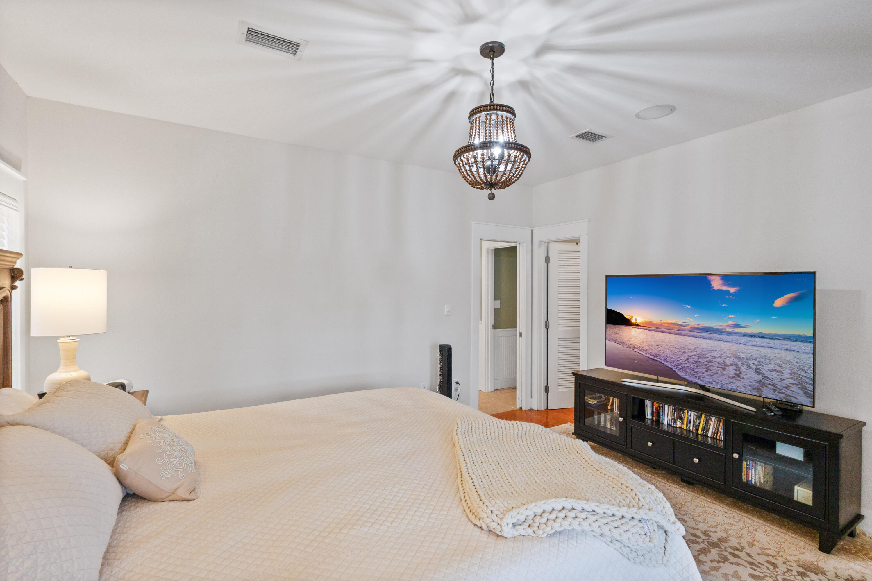 58 South Summit Drive Santa Rosa Beach, FL 32459 - Photo 21 of 40 a bedroom with a bed and a chandelier