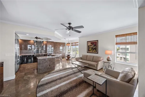 a living room with furniture a table and a large window