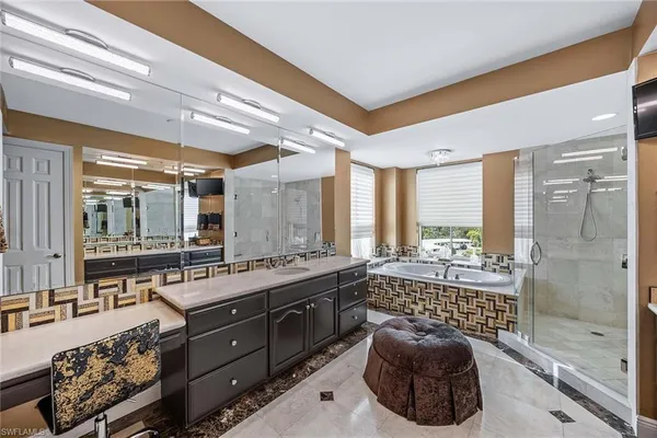 a large bathroom with a large tub and shower