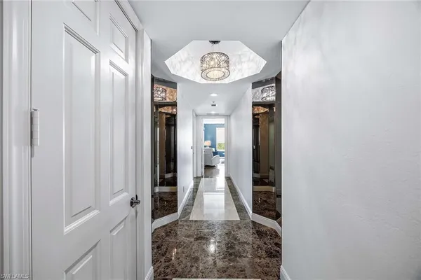 a view of a hallway with wooden floor and a hallway