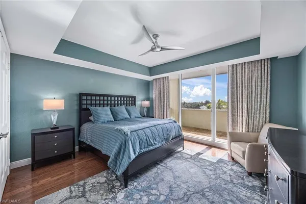 a spacious bedroom with a bed and glass door