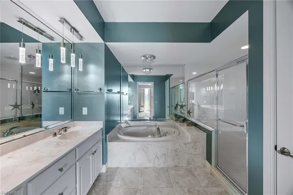 a large bathroom with a double vanity sink and mirror