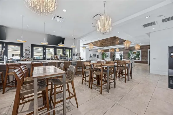 a view of a dining room with furniture and chandelier
