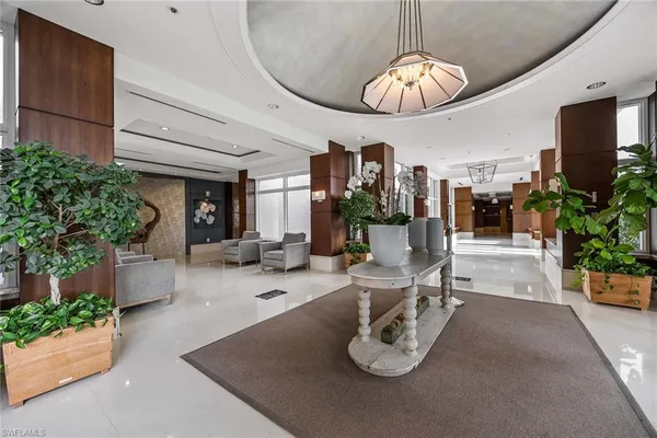 a dining room with furniture and a chandelier
