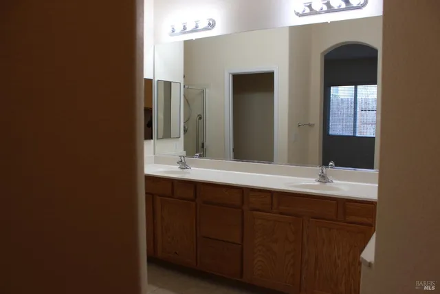 a bathroom with a tub a sink and mirror