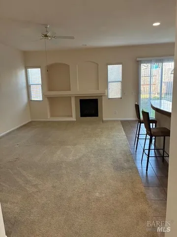 a view of kitchen with refrigerator and window