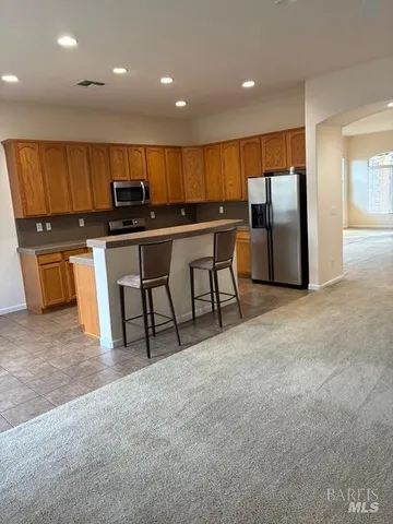 a kitchen with a stove a sink and a counter top space