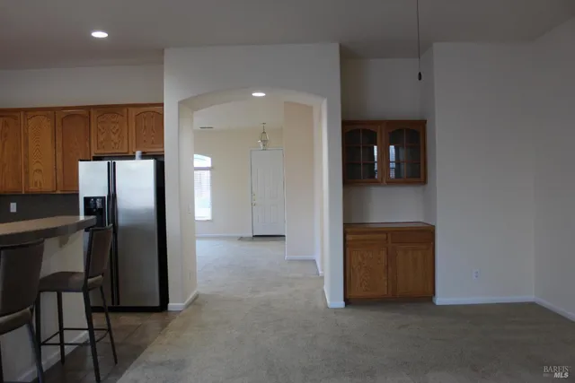 a kitchen with kitchen island a white counter top space cabinets and stainless steel appliances
