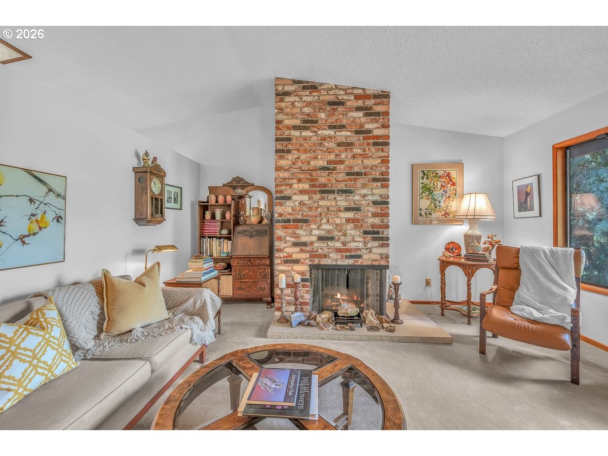 9200 Southwest Elrose Court Portland, OR 97224 - Photo 11 of 46 a living room with furniture and a fireplace