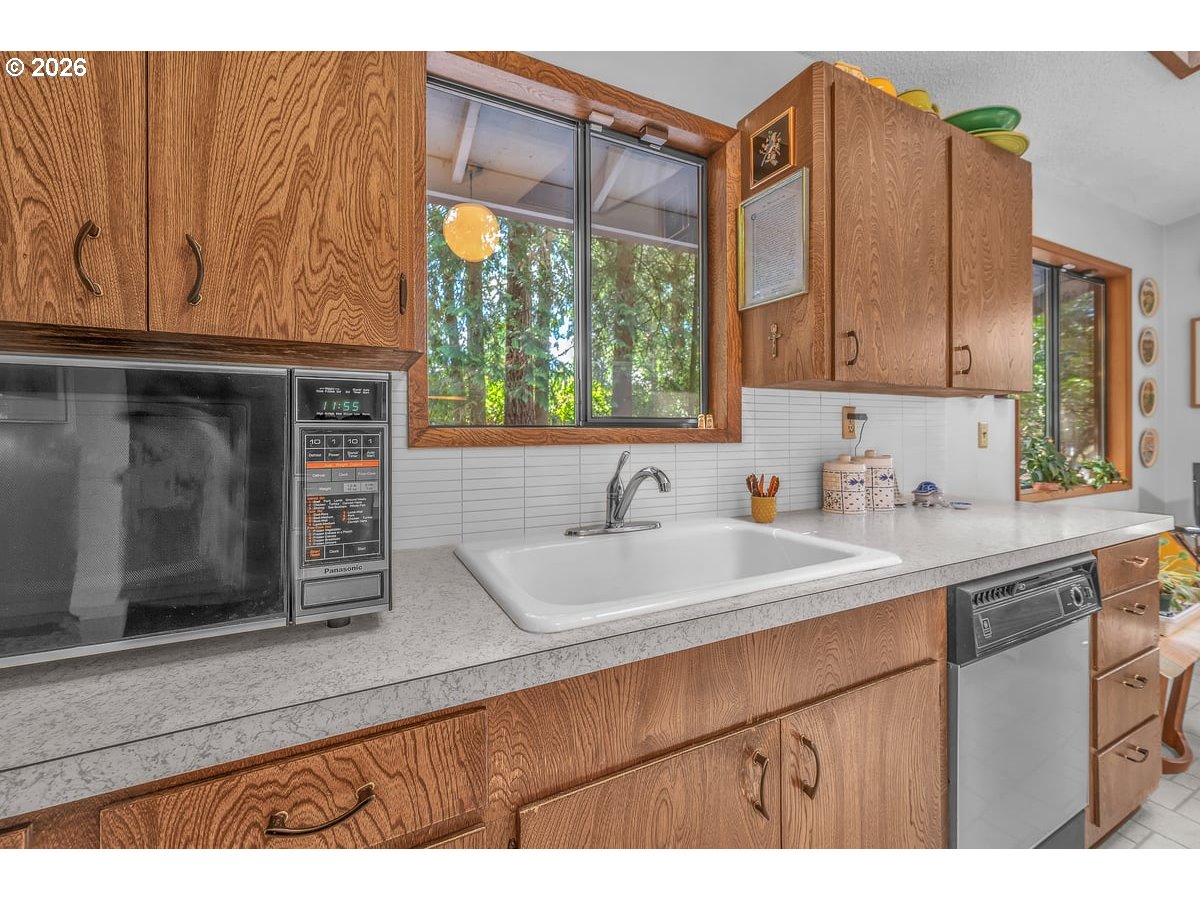 9200 Southwest Elrose Court Portland, OR 97224 - Photo 20 of 46 a kitchen with a sink and a microwave