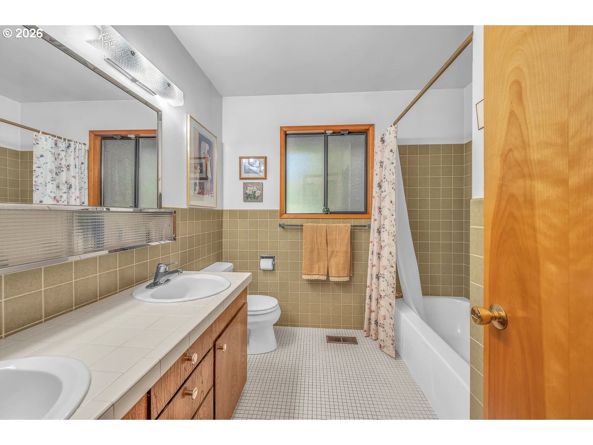 9200 Southwest Elrose Court Portland, OR 97224 - Photo 23 of 46 a bathroom with a sink a toilet and shower