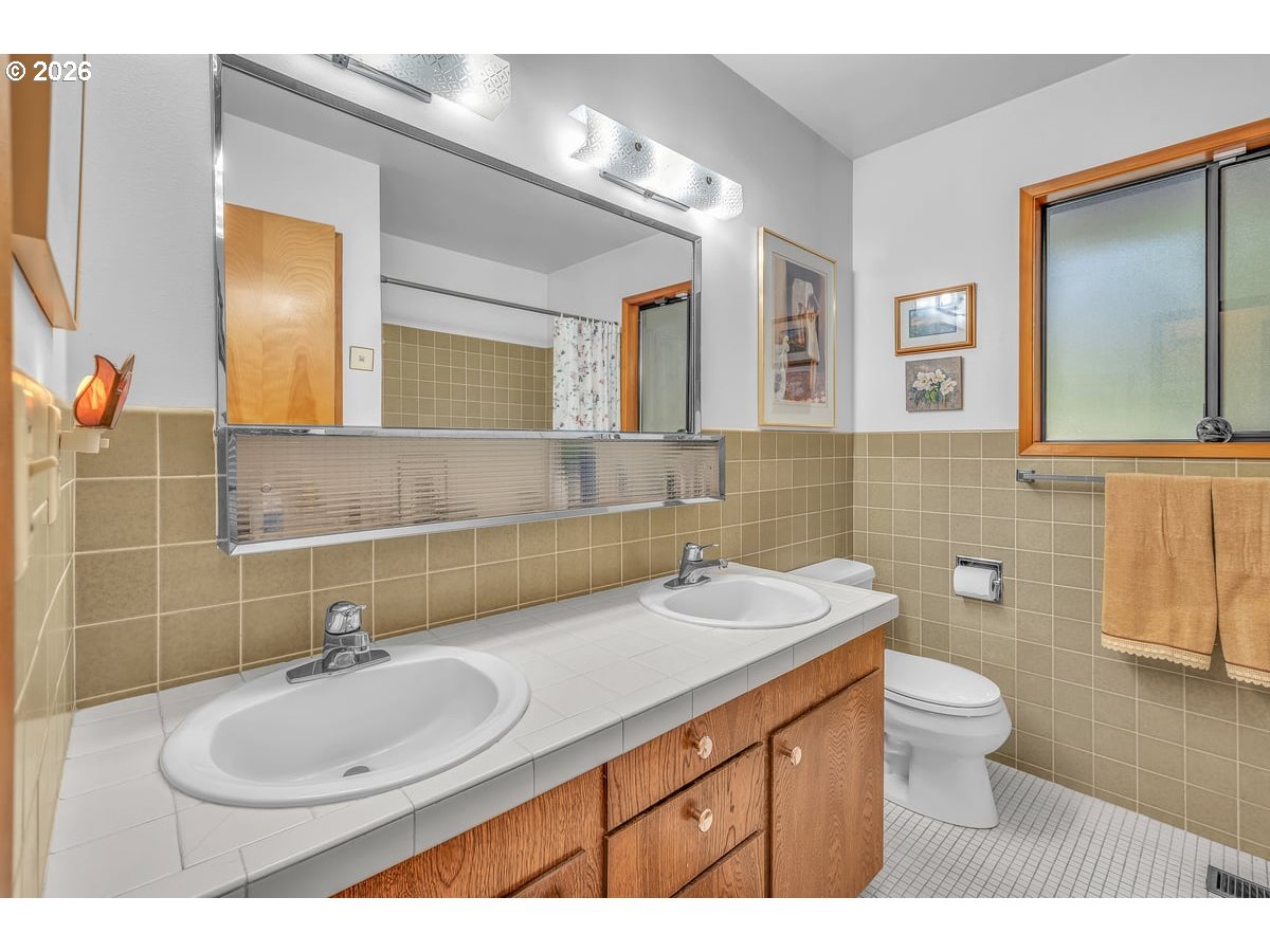 9200 Southwest Elrose Court Portland, OR 97224 - Photo 24 of 46 a bathroom with a sink and a mirror