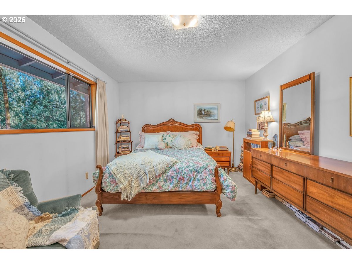 9200 Southwest Elrose Court Portland, OR 97224 - Photo 27 of 46 a bedroom with a bed and wooden floor