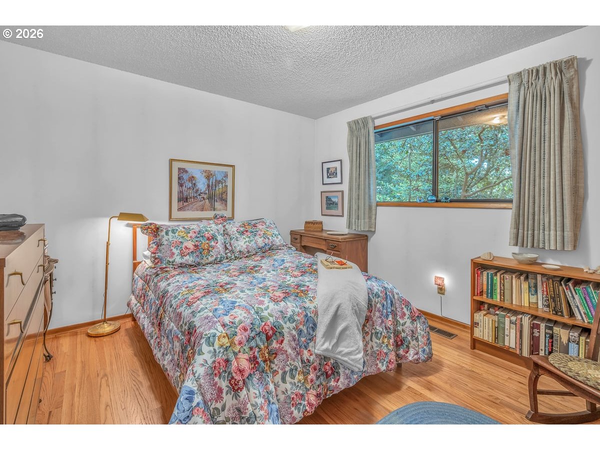9200 Southwest Elrose Court Portland, OR 97224 - Photo 28 of 46 a bed sitting in a bedroom next to a window