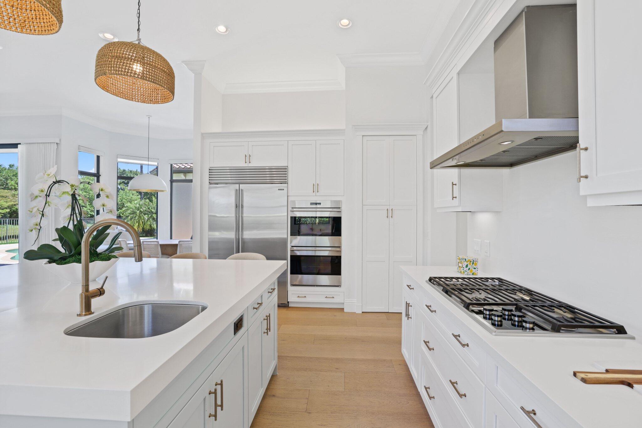 9599 Moritz Way Delray Beach, FL 33446 - Photo 22 of 75 a kitchen with stainless steel appliances granite countertop a sink and a stove