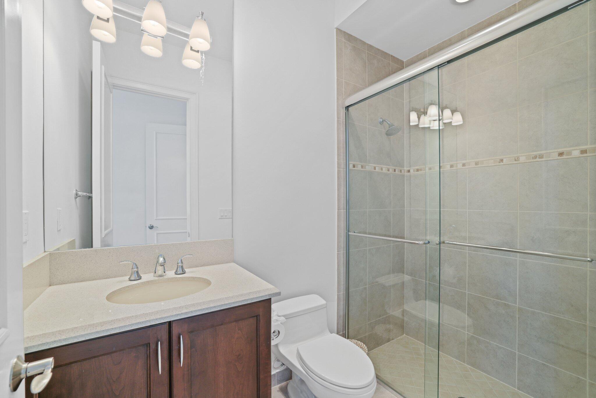 9599 Moritz Way Delray Beach, FL 33446 - Photo 44 of 75 a bathroom with a sink a toilet and shower