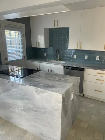 a kitchen with a sink cabinets and window