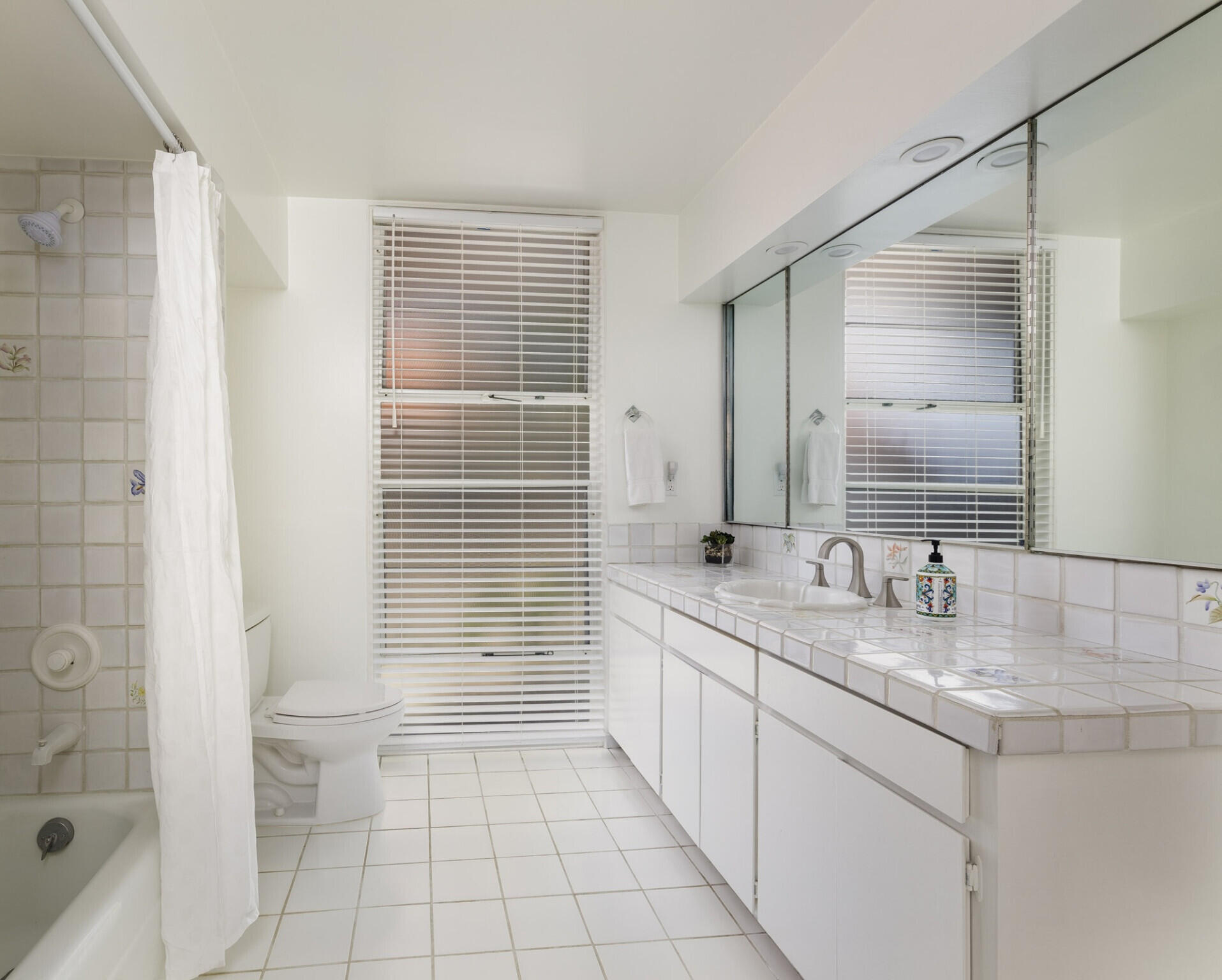 950 Monte Drive Santa Barbara, CA 93110 - Photo 29 of 39 a bathroom with a double vanity sink toilet and shower