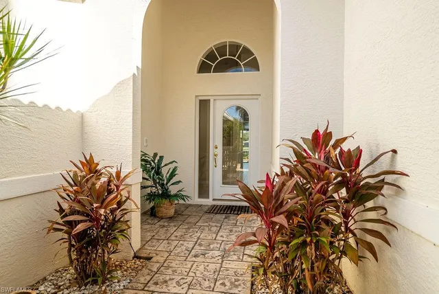a vase of flowers sitting on a floor