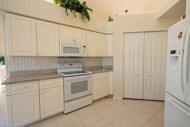 a kitchen with stainless steel appliances a sink and a refrigerator