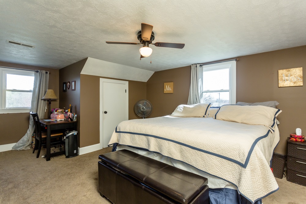 8687 Union Springs Road Dayton, VA 22821 - Photo 11 of 37 a bedroom with a bed and a chandelier