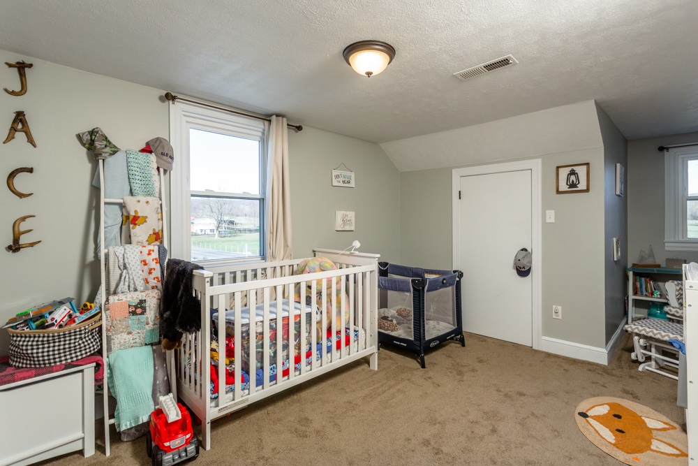 8687 Union Springs Road Dayton, VA 22821 - Photo 12 of 37 a bedroom with furniture and baby crib