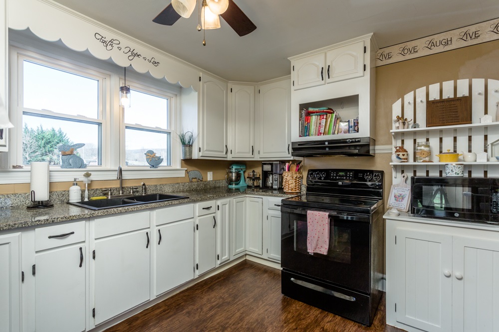 8687 Union Springs Road Dayton, VA 22821 - Photo 2 of 37 a kitchen with stainless steel appliances granite countertop a stove and a sink
