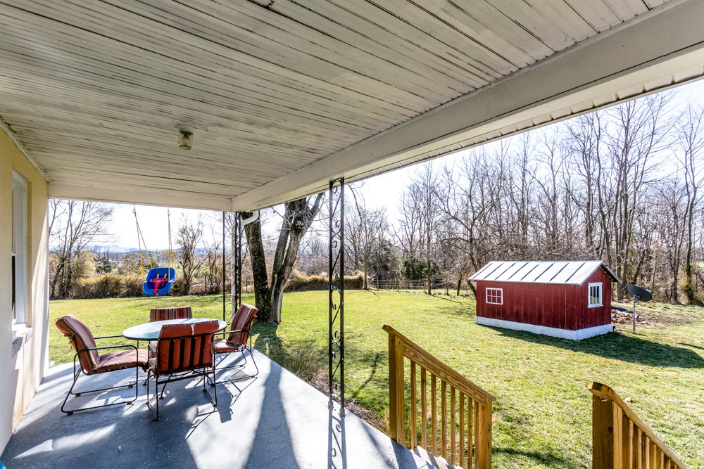8687 Union Springs Road Dayton, VA 22821 - Photo 27 of 37 a view of chairs and table in patio with a yard