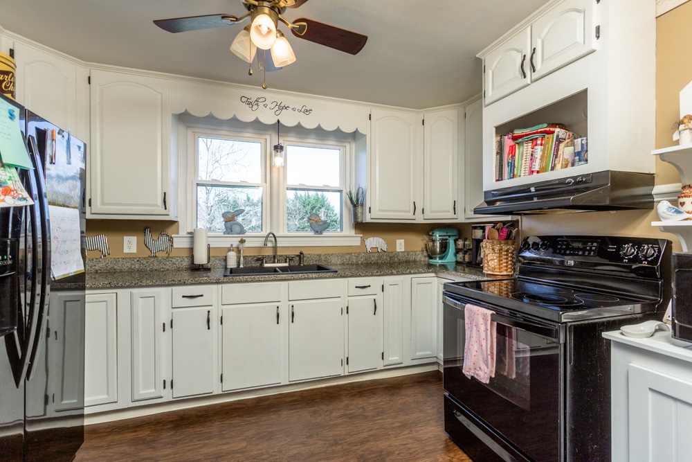 8687 Union Springs Road Dayton, VA 22821 - Photo 3 of 37 a kitchen with stainless steel appliances granite countertop a stove and a sink