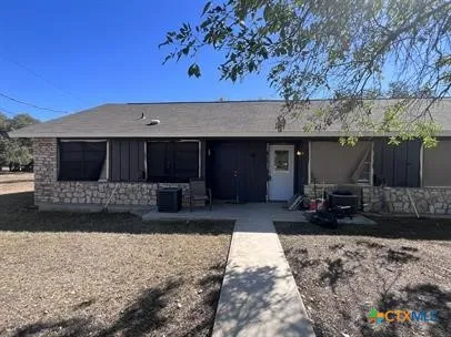 a front view of a house with a yard and a couch