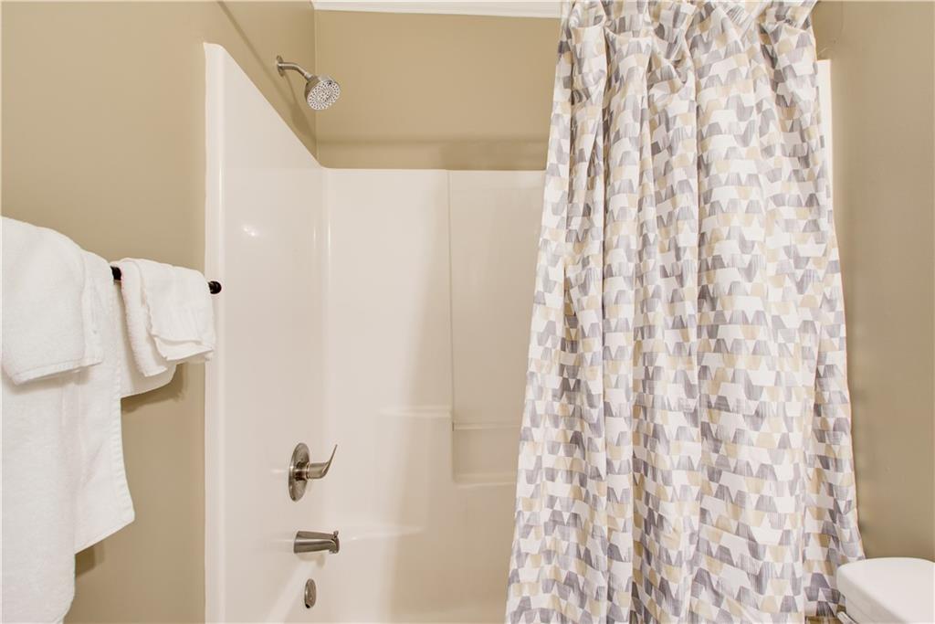 1979 Trinity Mill Drive Dacula, GA 30019 - Photo 11 of 26 a bathroom with a shower curtain and a curtain