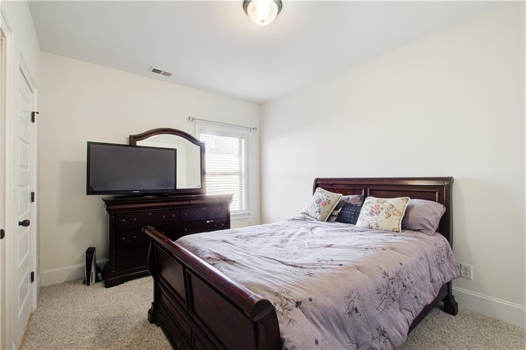 1979 Trinity Mill Drive Dacula, GA 30019 - Photo 14 of 26 a bedroom with a bed and a television