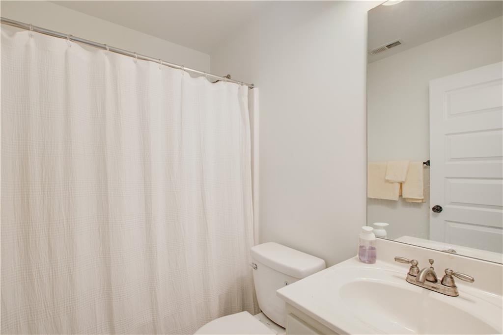 1979 Trinity Mill Drive Dacula, GA 30019 - Photo 16 of 26 a bathroom with a sink a toilet and a mirror