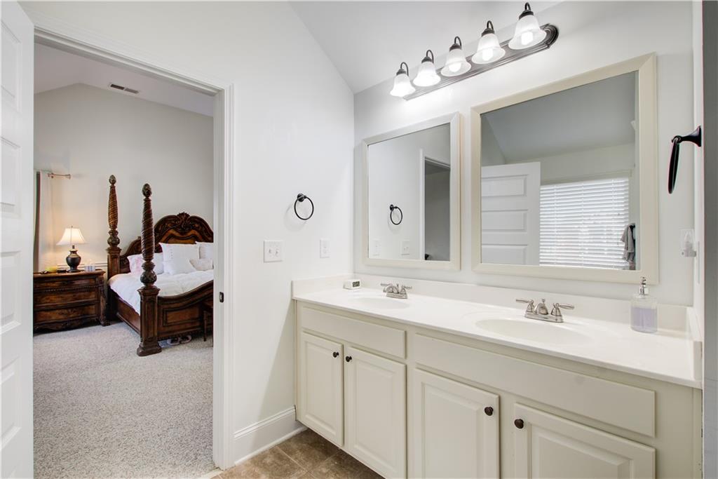 1979 Trinity Mill Drive Dacula, GA 30019 - Photo 25 of 26 a en suite bathroom with a double vanity sink and a mirror