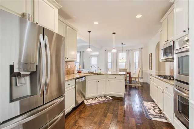 a view of a dining room with furniture and chandelier