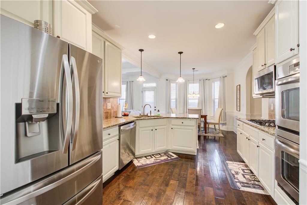 1979 Trinity Mill Drive Dacula, GA 30019 - Photo 6 of 26 a large kitchen with a large window and stainless steel appliances