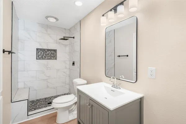 a bathroom with a sink toilet and shower