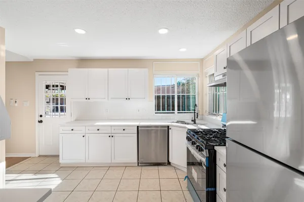 a kitchen with a sink stove and cabinets