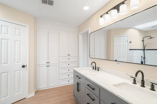 a bathroom with 2 sink and a mirror