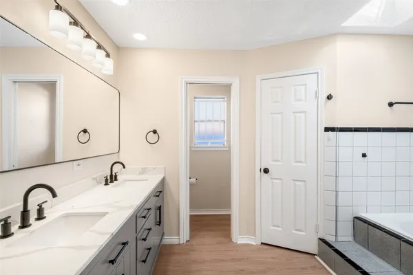 a bathroom with a double vanity sink a mirror and a shower