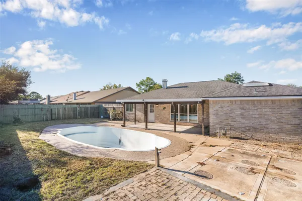 a front view of a house with swimming pool and sitting area