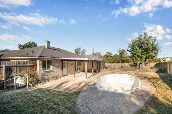 a view of swimming pool with a patio and a yard