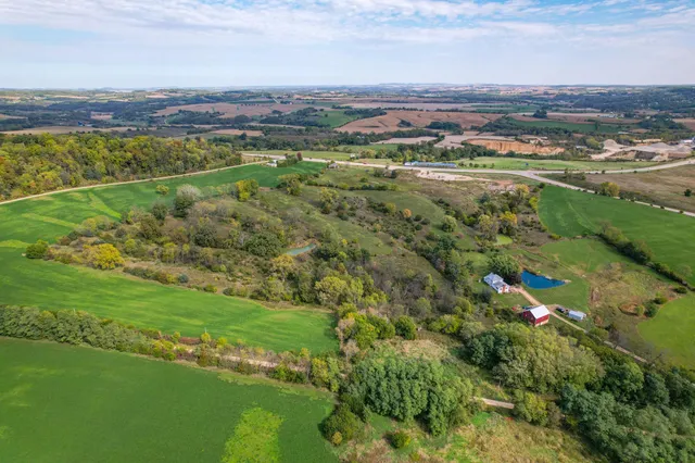 an aerial view of ocean with residential houses with outdoor space