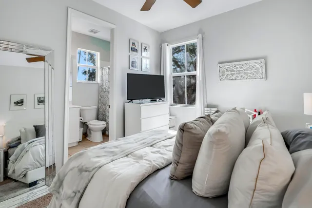 a bedroom with a bed and a flat screen tv