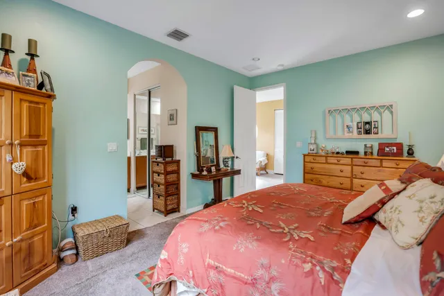 a bedroom with a bed and dresser