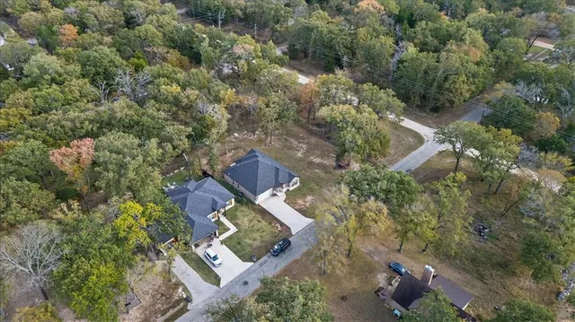 an aerial view of a house with outdoor space and street view
