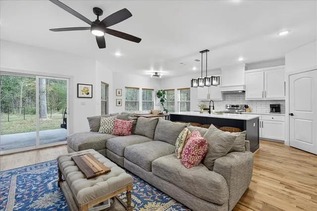 a living room with furniture and kitchen view